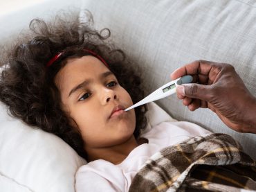 world-pandemic-sick-little-girl-with-high-fever-an-XSA2L9F.jpg